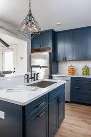 Brushed brass cabinet pulls against light blue cabinets. What S Hot On Pinterest Pastel Pink Home Offices Are In Unique Blog Blue Kitchen Designs Navy Blue Kitchen Cabinets Kitchen Cabinets For Sale