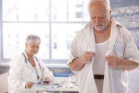Mature Male Patient Undressing At Doctor's Room. Stock Photo, Picture and  Royalty Free Image. Image 10373379.