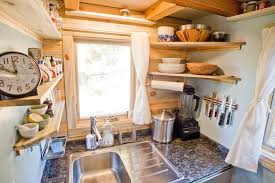 In this small space, black and white granite countertops extend up the walls for a seamless appearance. 8 Space Making Hacks For Small Kitchens