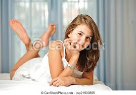 Get this image in a variety of framing options at photos.com. Cute Teen Girl Relaxing On Bed Portrait Of Smiling Teen Girl At Home In White Dress And Relaxing On Comfortable Bed Luxury Canstock