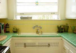 The color brightens the room, and the enamel finish is easy to clean. Yellow And Green Tile Green Tile Modern Farmhouse Kitchens Small Kitchen Storage Solutions