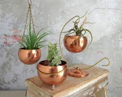 Copper planters tend to deter pests like slugs and snails and conduct heat so the soil heats up in direct sunlight. Coppercraft Guild Copper Planter Pot Collection Hanging Copper Planters Footed Pot Vintage Mid Century Modern Copper Decor Vintage Planters Copper Planters
