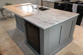 The cooktop is surrounded by white cabinets which pair with brushed nickel hardware and moon white granite counters alongside a subway tiled backsplash flanked by a double wall oven to the left and two door refrigerator to the right situated under dark gray cabinets painted benjamin moore. Moon White Quartzite Worktops Algarve Granite Northampton Craftsmen In Natural Stone