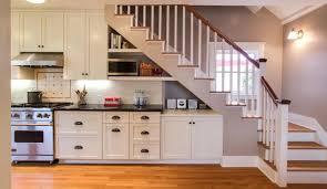 The lowest level is an entry and kitchen space, and a few steps up is the main living area. Unbelievable Kitchens Placed Under The Stairs That You Should See Today Look Fabulous Decoratorist