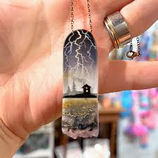 Faryn Davis of Fernworks creates tiny, intricate worlds in resin and  gemstones. Each scene is painted with toothpicks and brushes, layered into  epoxy, and polished into dreamlike 3-D landscapes. I'm in awe