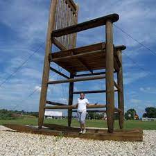 It's a fun one, because sitting on the edge of the seat with your legs dangling down, you appear tiny. Big John The World S Largest Wooden Rocking Chair Long S Furniture World And Mattress