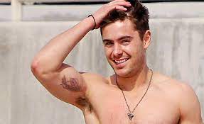 In the picture zac shows tattoo of numbers 818 on his inner arm and a huge fiery dragon tattoo on his side. Zac Efron S 2 Tattoos Their Meanings Body Art Guru