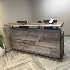 Beautiful Custom Built Reception Desk With Authentic Barnwood Paneling Paired With Functional Design Wood Reception Desk Reception Desk Reception Desk Design