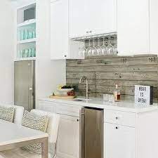 So even though farmhouse kitchens tend to pair well with stone backsplashes, you can still choose to use a white subway tile to contrast your wood cabinets, stone floors and butcher block countertops. White Plank Backsplash Design Ideas
