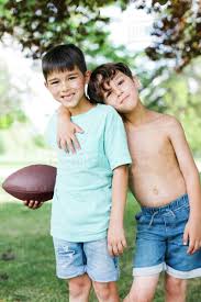 A few have returned wit. Young Boys 6 7 8 9 With American Football Ball Stock Photo Dissolve
