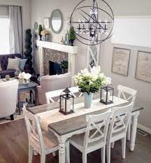 This dining room features wooden dining table paired with modern chairs along with white bookshelves. Modern French Country Neutral Grey And White Palette Farmhouse Dining Room Farmhouse Dining Room Table Farmhouse Dining
