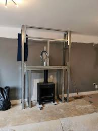This option is for a house with no chimney, but the flue cannot go up through to the roof for various reasons, then a false chimney breast is built, the stovebox is inserted and the twinwall goes up only to the first metre above the top of the box and then at an angle out through to the exterior up to the recommended height. False Chimney Breasts Tjs Installations