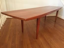 This stunning coffee table is handcrafted from reclaimed and unfinished raw teak driftwood and topped with a round clear glass top allowing one to admire the sculptural teak below. Mid Century Danish Modern Solid Teak Coffee Table Epoch