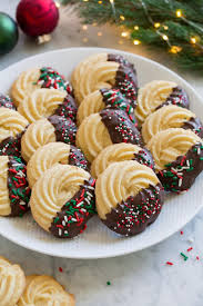 Butter Cookies Dipped In Chocolate And Covered In Sprinkles Shown In Rows On A White Serving Pl Cookies Recipes Christmas Christmas Food Butter Cookies Recipe
