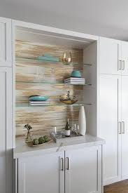 Gray And Gold Metallic Wallpaper Is Fixed Behind Stacked Glass Front Shelves Mounted Above White Sh Glass Shelves Glass Shelves Kitchen Gold Metallic Wallpaper
