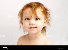 Red haired toddler with messy hair Stock Photo