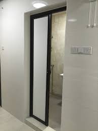 Contemporary bathroom design, bathroom with freestanding bathtub, black metal frame shower doors, terrazzo floor. Bathroom Door
