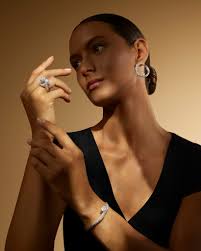 Embrace the art of self-gifting with the diamond ring of your dreams.  Featuring a showstopping, 11.65 carat fancy intense yellow diamond and two  masterfully cut pear-shaped white diamonds, this cushion-cut ring is