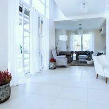 In this gorgeous living room, the flooring is installed diagonally: Pure White Lappato Porcelain Tile Western Distributors