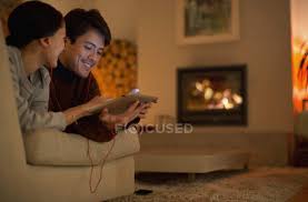 All that was missing in the place was a coffee bar. Happy Couple With Headphones Sharing Digital Tablet On Living Room Sofa Togetherness Two People Stock Photo 255213552