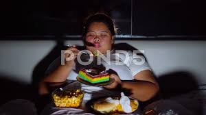 Fat attractive woman lying on gym floor with a massive cake. Eating Cake Stock Video Footage Royalty Free Eating Cake Videos Page 19