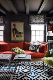 Grey living room with hints of orange from the pillows, glass decors, and hardwood flooring. Colors That Go With Gray Best Accent Colors To Pair With Gray