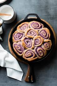 If You Love Cinnamon Rolls And Have Ever Tried Sweet Potato Cinnamon Rolls Then These Coconut Ube Rolls A In 2020 Sweet Potato Cinnamon Sweet Potato Buns Ube Recipes