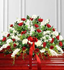 A casket spray is a bouquet of flowers that is specifically made to send to a funeral home to help mourn the loss of a loved one. Red White Casket Spray Avas Flowers