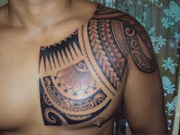 A badass tribal tattoo with polynesian motives inked on from the man's chest to his arm. 45 Tribal Chest Tattoos For Men