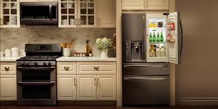 A pair of floral round back chairs sit at a central island in this kitchen showcasing black appliances the complement with the diamond pattern tiled backsplash. 20 Stainless Steel Kitchen Appliances Magzhouse