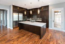 Wood floors in a walnut. Modern Kitchen With Dark Cabinets And White Quartz Counters Homes By Dephillips Dark Kitchen Minimalist Kitchen Cabinets Minimalist Kitchen Design