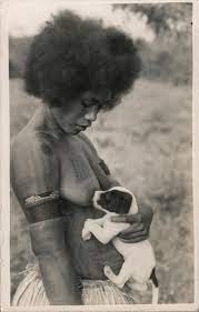 By leslie goldman for thebump.com. African Woman Breast Feeding Puppy Postcard