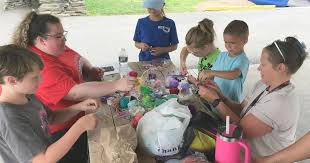 Kids make dream catchers as part of summer program in Rome