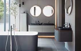 A mix of ann sacks surfaces, including a pebble wall covering, brings a warm feel to a guest bath of an aspen, colorado, home which was renovated by stonefox architects. Designer Bathrooms Luxury Bathroom Suites