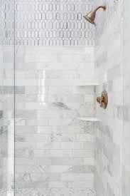 Stunning bathroom floor composed of marble basketweave tiles and subway tile baseboard. Corner Shower Displays Mixed Stacked Marble Tiles Complimenting Carrera Marble Hex Flooring Shower Shelves Shower Remodel Shower Tile