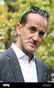Shake Shack CEO Randy Garutti, center, joined by company CFO Jeff Utz,  left, and founder Danny Meyer, celebrate during opening bell ceremonies at  the New York Stock Exchange, Thursday, Jan. 14, 2016. (