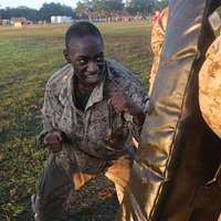 A visitor poses for a photo while getting his face