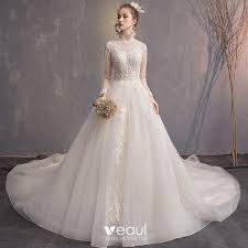 A train is an extra length of fabric that extends from the back of your wedding dress and trails behind you as you walk. Elegant Champagne Wedding Dresses 2019 A Line Princess High Neck Beading Pearl Tassel Lace Flower Long Sleeve Backless Cathedral Train