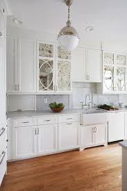 Many of our available patterns are shown below; Smoked Mirror Cabinet Doors In A White Kitchen Designed With Chrome Pulls Honed Marble Countertops A Mirrored Kitchen Cabinet Kitchen Redesign Kitchen Remodel