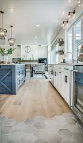 This style can be achieved with everything from farmhouse sinks, to light. Modern Farmhouse Kitchen With Blue Kitchen Island And Hexagon Tiles And Timber Floors Interior Design Kitchen Farmhouse Kitchen Decor Eclectic Farmhouse