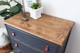 Sleek, varnished wood adds a touch of class. Navy Blue Diy Dresser Makeover