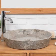 An eclectic bathroom featuring an oval tub, marble tiles and shiny ones on the wall, a floating vanity and mirror cabinets. Marble Bathroom Basin Sinks For Sale Uk Wanda Collection