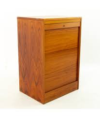 A large selection of furniture, mid century danish sofas, armchairs and retro sideboards. Danish Mid Century Teak Tambour Door Lockable File Cabinet