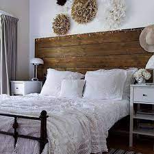 A pastel vintage bedroom with light green walls, a metal bed, neutral furniture, whitewashed decor and a fringe piece plus a crystal chandelier. Tips And Ideas For Decorating A Bedroom In Vintage Style