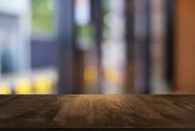 empty dark wooden table in front of abstract blurred bokeh background of restaurant dark wooden table wooden tables bokeh background