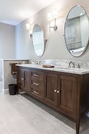 Furniture Vanity In A Walnut Finish Custom Double Sink Vanity Is Centered Between Two W Double Vanity Bathroom Double Sink Bathroom Vanity Bathrooms Remodel