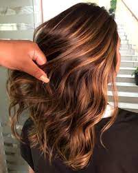 The hair starts off dark and goes into a caramel shade and ends with blonde tips. 60 Looks With Caramel Highlights On Brown And Dark Brown Hair Highlights Brown Hair Balayage Strawberry Blonde Highlights Brown Blonde Hair