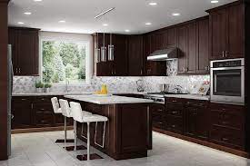 Dark cabinets don't have to be black—if the midnight mood isn't for you, consider a lighter shade of brown. Modern Kitchen Backsplash For Brown Cabinets Novocom Top