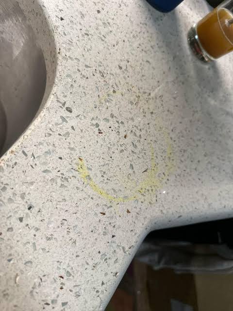 Yellow turmeric rings on light quartz counters require non-acidic oxidation, AI generated