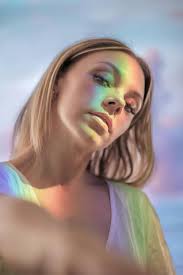 Sensual woman with blond hair and rainbow ray